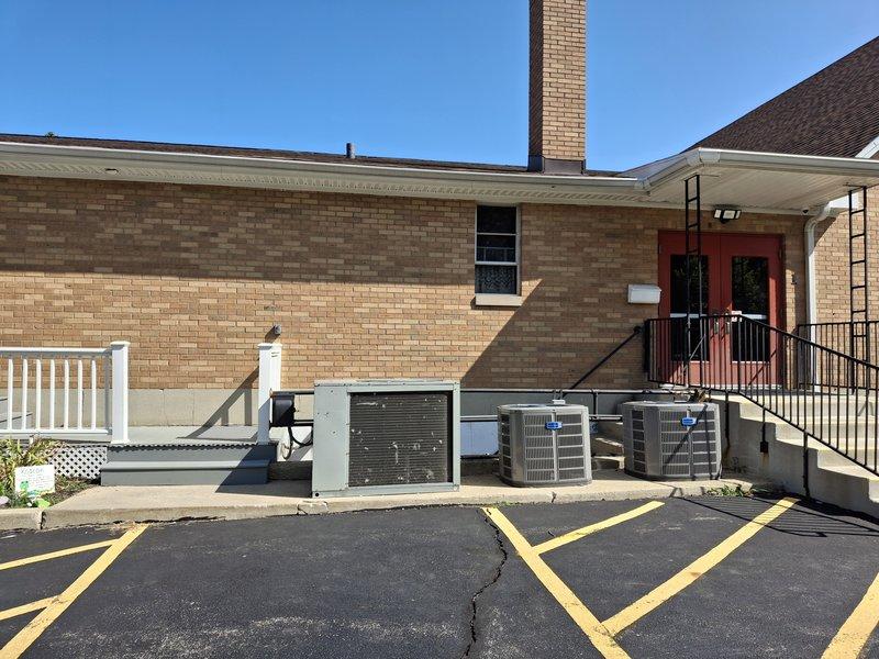 Conducted commercial HVAC sales estimate for no cooling condition at commercial facility with multiple rooftop condenser units installed on exterior concrete pad. Performed site assessment and took measurements of existing equipment installation area and clearances to determine proper sizing and placement requirements for air handler replacement. Documented current system configuration including multiple AC condenser units servicing the building to prepare comprehensive equipment replacement proposal.