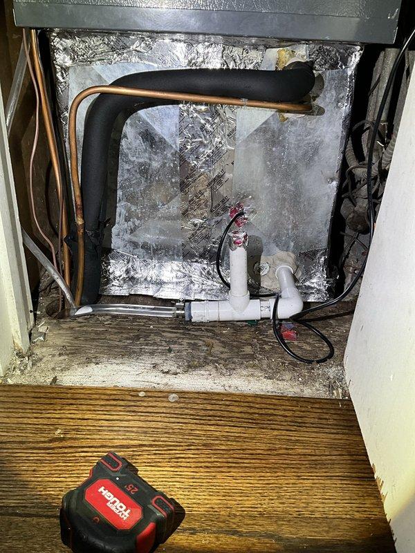 Responded to no cooling call on one-year-old Goodman residential system that had been previously serviced 4-5 times by installing contractor without resolution. Upon inspection, discovered evaporator coil completely frozen with extensive ice buildup on refrigerant lines and surrounding surfaces. Identified restricted airflow as root cause due to severely clogged air filter and inadequate return air, causing coil temperature to drop below freezing point. Shut down system to allow coil to thaw completely, replaced air filter, verified proper airflow across evaporator, and checked refrigerant charge levels. Once thawed, restarted system and confirmed proper operation with adequate cooling and no further ice formation. Educated homeowner on importance of regular filter changes and proper system maintenance to prevent recurrence.