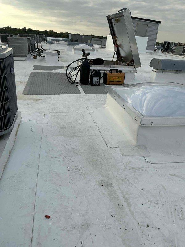 Successfully completed installation of a 2-ton Trane air conditioning system on a commercial rooftop. The condenser unit was manually lifted and positioned through the building's roof hatch access with a three-person crew, eliminating the need for crane equipment. All refrigerant lines, electrical connections, and control wiring were installed per manufacturer specifications, with the system tested and verified operational upon completion.