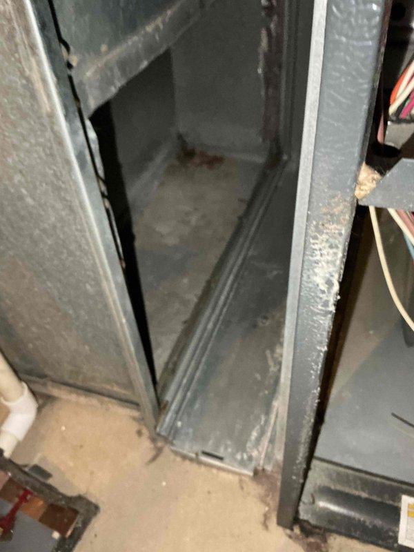 Completed comprehensive BFMA tune-up service on 11-year-old HVAC system during morning appointment window. Performed full AC system inspection and maintenance, including evaluation of compressor unit, refrigerant lines, evaporator coil assembly, and condensate drainage system. Noted rust staining and corrosion present on base pan with moisture accumulation, indicating normal condensate collection activity. Inspected air handler cabinet interior, assessed electrical connections and wiring integrity, and evaluated overall system operation. Replaced 20x25x5 air filter as part of semi-annual filter change service. Documented equipment condition through photographic records showing interior components including compressor assembly, copper refrigerant tubing, evaporator coil, drain pan, and air handler cabinet. System operational upon completion of tune-up procedures.