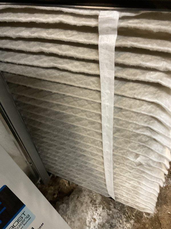 Completed comprehensive BFMA air conditioning tune-up on 4-year-old cylindrical coil condenser unit. Performed standard maintenance protocol including inspection of outdoor condenser with teal housing and wrapped coil design, noting dirt and dust accumulation on coil fins requiring attention. Critical finding: discovered severe icing condition on air filter with substantial icicle formation extending 8-10 inches, indicating restricted airflow and potential refrigerant charge issues or airflow imbalance causing evaporator coil freeze-up. Addressed moisture and freezing concerns, cleaned accumulated debris from condenser surfaces, and verified system operation parameters to prevent further ice buildup and ensure proper cooling performance.