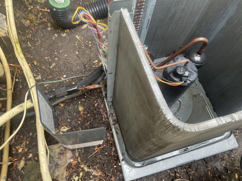 Completed comprehensive AC tune-up maintenance on outdoor condensing unit. Removed significant accumulation of leaves, organic debris, and decomposed material from compressor compartment and base pan that had restricted airflow. Inspected refrigerant lines, electrical connections, and condenser coils; verified all components operating within normal parameters.