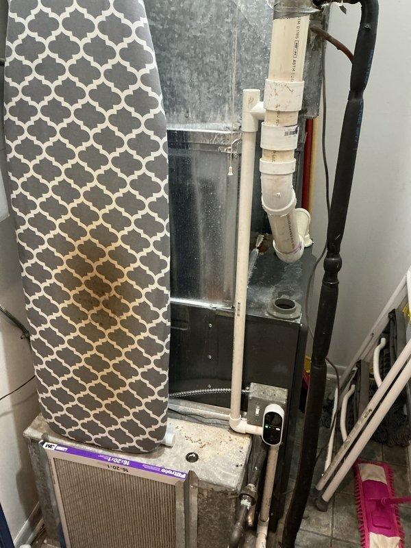 Evaluated existing HVAC system in in-law suite consisting of a 1991 outdoor condensing unit and similarly-aged air handler for full system replacement estimate. The air conditioning unit is struggling to maintain adequate cooling capacity, with visible deterioration including paint flaking and weathering on the outdoor unit housing. Both the condensing unit and furnace are at end of service life and recommended for simultaneous replacement due to age and condition to ensure system compatibility and efficiency.