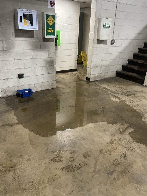 Responded to commercial facility for recurring toilet backup issue. Upon arrival, found significant water flooding in basement level and standing water in main floor entryway, indicating sewage backup from restroom fixtures. Deployed wet floor safety signage and extracted standing water from affected areas using vacuum equipment. Cleared main sewer line obstruction causing backup to multiple toilet fixtures. Verified proper drainage and flow restoration to all affected plumbing fixtures before completing service.