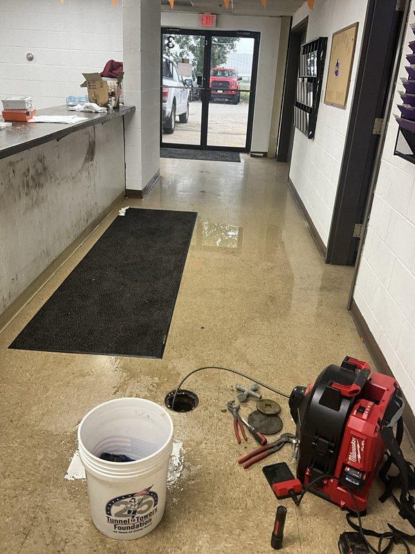 Responded to commercial facility for recurring toilet backup issue. Upon arrival, found significant water flooding in basement level and standing water in main floor entryway, indicating sewage backup from restroom fixtures. Deployed wet floor safety signage and extracted standing water from affected areas using vacuum equipment. Cleared main sewer line obstruction causing backup to multiple toilet fixtures. Verified proper drainage and flow restoration to all affected plumbing fixtures before completing service.