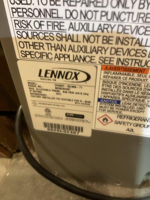 Responded to service call for newly installed Lennox furnace (Model GK40DT) with reported water leakage on floor and surrounding dampness. Upon arrival, unit was shut off by homeowner due to concerns about potential mold growth and lack of cooling on first floor while second floor maintained cold air. 

Performed diagnostic inspection and documented extensive condensation throughout the unit's internal components. Visual examination revealed significant moisture accumulation on copper refrigerant lines, compressor housing, and metallic surfaces within the air handler compartment. Water droplets were clearly visible coating refrigerant tubing and other components, indicating active condensation issues. Inspected white PVC condensate drainage system and verified proper installation of drain lines. 

Examined A2L refrigerant system specifications and confirmed unit is operating with appropriate safety classifications. Checked all accessible components including mesh filter, insulated copp