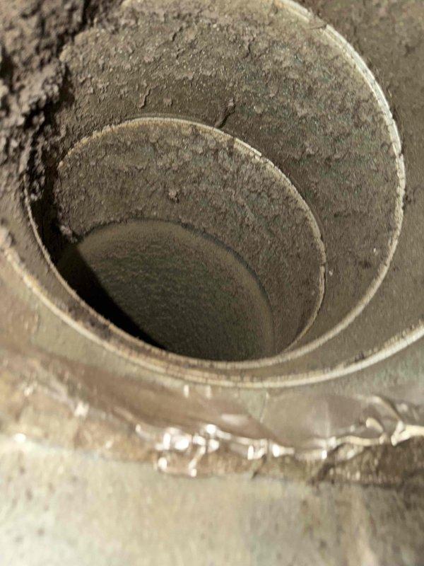 Completed comprehensive indoor air quality service including full duct system cleaning to remove accumulated dust and debris throughout the ductwork, as evidenced by heavy buildup found in spiral duct components. Performed blower wheel cleaning and indoor coil cleaning to restore system efficiency. Installed air scrubber on downflow system with mag light technology and added ductwork in attic space, utilizing 1110 or 1410 sizing as appropriate based on equipment clearances. Completed necessary duct repairs in attic area to ensure proper system sealing and performance.