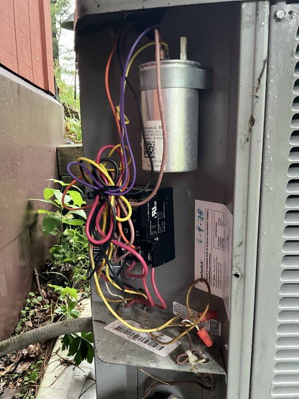 Installed hard start kit on outdoor air conditioning condenser unit to improve compressor starting performance and reduce electrical stress during startup. Accessed unit's electrical compartment, connected hard start capacitor in parallel with existing run capacitor using appropriate wiring, and verified all electrical connections were secure before closing access panel and testing system operation.