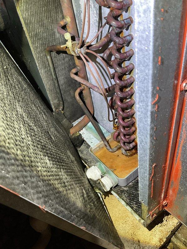 Responded to service call for backed-up condensate drain in crawl space on 20+ year old air conditioning system. Upon arrival, found unit operational and producing cool air as reported. Inspected condensate drainage system and cleared blockage from drain line. Verified proper drainage flow and confirmed system operation. Customer advised of unit age and condition but declined replacement at this time. No further issues found during inspection.