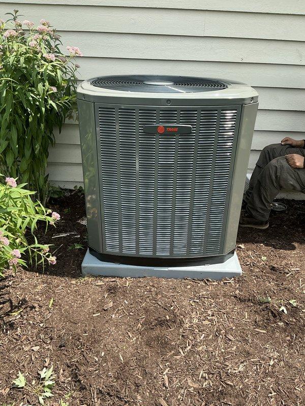 Completed installation of upgraded Trane 16 SEER air conditioning system, including model 5TTR6042 outdoor condenser unit and 5PXCC007 evaporator coil. Installed new 30-amp 2-pole GE circuit breaker for proper electrical service, ran refrigerant lines, and reinstalled existing thermostat to maintain customer's preferred control interface.