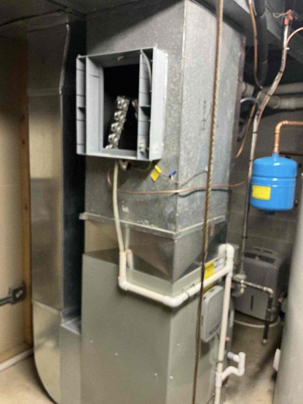 Completed installation of upgraded Trane 16 SEER air conditioning system, including model 5TTR6042 outdoor condenser unit and 5PXCC007 evaporator coil. Installed new 30-amp 2-pole GE circuit breaker for proper electrical service, ran refrigerant lines, and reinstalled existing thermostat to maintain customer's preferred control interface.