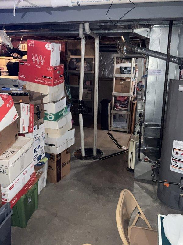 Performed complimentary inspection of two sump pump systems and ejector pump in residential basement. Conducted visual assessment of primary sump pump installation, verifying proper PVC discharge piping configuration, check valve operation, and float switch functionality. Inspected secondary sump pump system for operational readiness and confirmed adequate basin depth and pump positioning. Examined vertical discharge piping secured with appropriate brackets and rubber couplings to accommodate vibration and thermal expansion. Evaluated ejector pump system and associated plumbing connections. All systems found to be in working order with no immediate concerns noted. Documentation photographs captured for maintenance records.