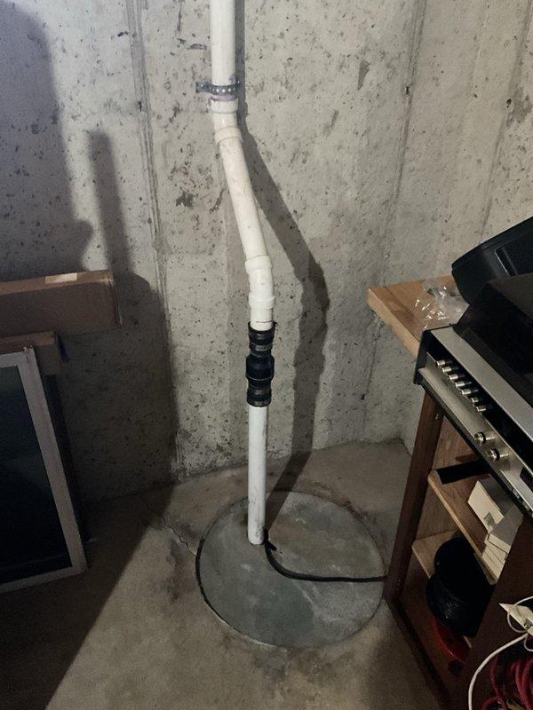 Performed complimentary inspection of two sump pump systems and ejector pump in residential basement. Conducted visual assessment of primary sump pump installation, verifying proper PVC discharge piping configuration, check valve operation, and float switch functionality. Inspected secondary sump pump system for operational readiness and confirmed adequate basin depth and pump positioning. Examined vertical discharge piping secured with appropriate brackets and rubber couplings to accommodate vibration and thermal expansion. Evaluated ejector pump system and associated plumbing connections. All systems found to be in working order with no immediate concerns noted. Documentation photographs captured for maintenance records.