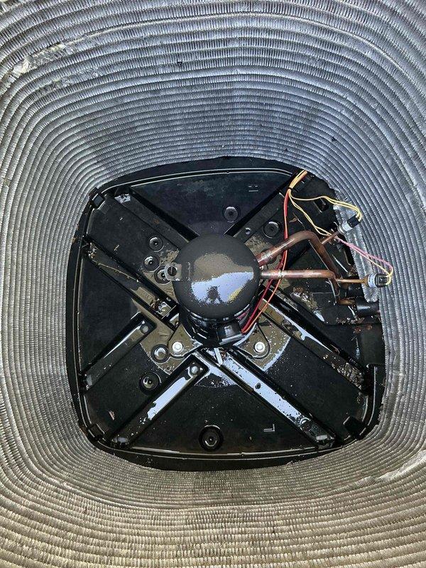 Completed BFMA preventive maintenance tune-up on outdoor air conditioning condenser unit. Removed top cover to access internal components and performed thorough inspection of condenser coil, which showed significant accumulation of dirt, dust, and debris throughout fin surfaces requiring cleaning. Inspected fan assembly, compressor, electrical connections, and structural mounting components to ensure proper operation and system integrity.