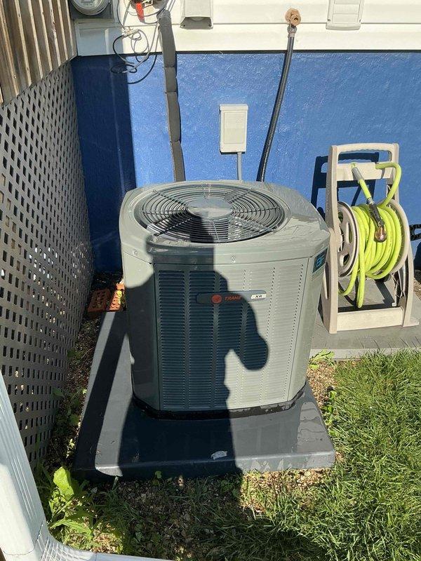 Completed comprehensive BFMA tune-up service on residential outdoor air conditioning unit aged 4+ years. Performed standard maintenance protocol including inspection of condenser unit, fan motor assembly, electrical connections, refrigerant lines, and disconnect box. All components found operating within normal parameters with proper mounting on concrete pad and secure electrical connections verified.