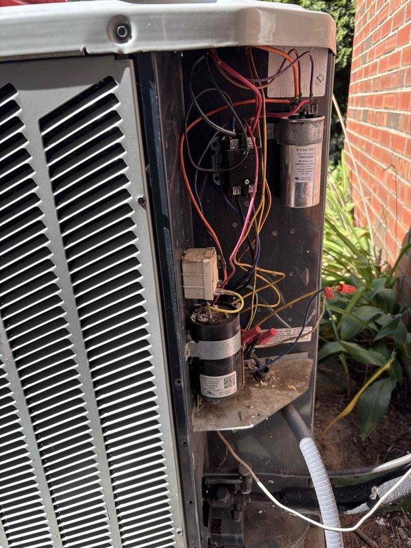 Responded to no cooling call where client reported hot air blowing through vents. Upon inspection, found failed dual run capacitor with visible internal deterioration and debris in top opening. Replaced defective capacitor, verified proper wire connections, and tested system operation. Unit restored to normal cooling function with proper airflow and temperature differential confirmed.