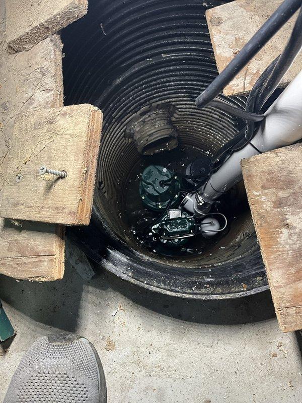 Replaced existing backup sump pump system with new AquaNot 508 Spin battery-powered backup unit. The backup pump was installed adjacent to the primary submersible pump in the existing sump basin to provide redundant drainage protection in the event of primary pump failure or power outage. System tested and verified operational with all indicator lights functioning properly on the control panel.
