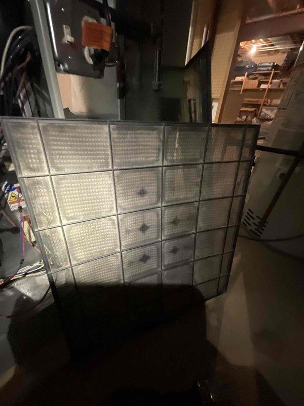 Completed comprehensive air conditioning tune-up on 8+ year old system with morning service window. Performed full system inspection of indoor and outdoor components, including evaporator coil assessment in basement utility area and thorough evaluation of outdoor condenser unit. Condenser coil exhibited heavy accumulation of dirt, dust, and debris on fins, requiring extensive cleaning to restore proper airflow and heat transfer efficiency. Cleaned condenser coils, checked refrigerant levels, inspected electrical connections, tested capacitors, and verified proper system operation. Unit restored to optimal performance with improved airflow through cleaned coil surfaces.