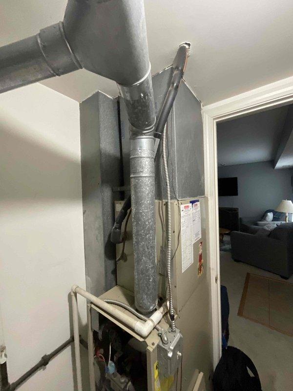 Completed on-site estimate for furnace replacement at residential property. Assessed existing HVAC system installation in utility closet, including beige air handler unit with insulated ductwork and flexible connectors. Documented current system configuration and mechanical room layout to provide accurate replacement recommendations and ensure proper sizing for new furnace installation.