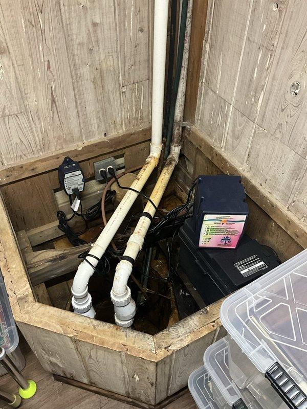 Responded to service call regarding malfunctioning sump pump system. Upon arrival, inspected dual sump pump installation located in wooden access pit with multiple discharge pipes and electrical connections. Evaluated both pump units, associated control boxes, and electrical wiring for proper operation and identified issues affecting system performance. Addressed problems with pump functionality to restore proper water removal capabilities and ensure reliable operation of the backup system.