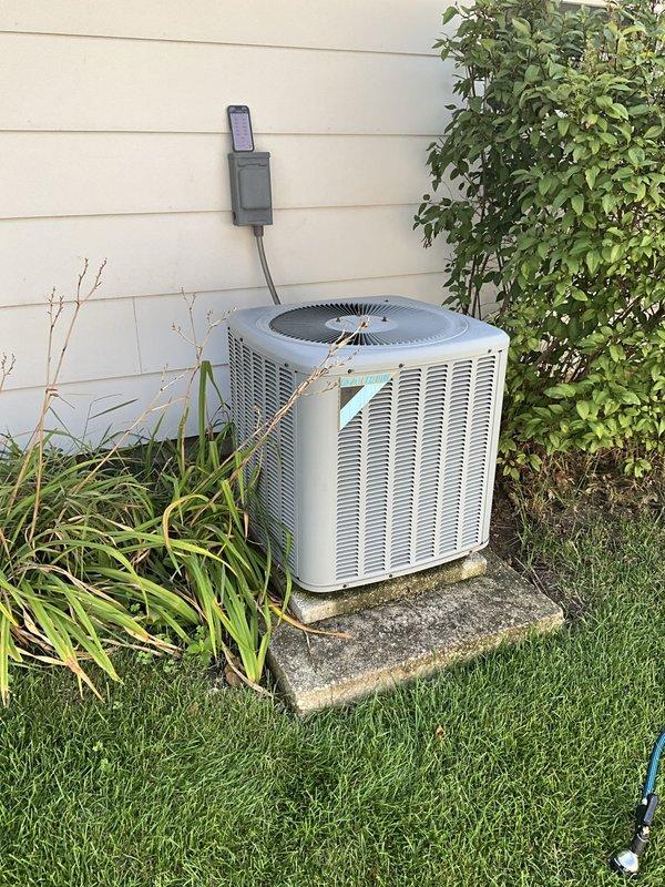 Completed comprehensive BFMA tune-up service on a 10-year-old residential air conditioning system. Performed full system inspection of outdoor condenser unit and indoor air handler components, including thorough examination of blower wheel assembly and ductwork. Inspected squirrel cage blower fan with cylindrical blade configuration, noting normal operational dust accumulation on blades and housing. Verified proper blower wheel rotation and clearances within metallic ductwork assembly. Examined outdoor condenser unit positioned on concrete pad, checking refrigerant lines, electrical disconnect, and conduit connections. Assessed condenser coil condition through vertical louvered panels and confirmed adequate airflow clearances around unit perimeter. Documented equipment condition through photographic records showing functional blower assembly with uniform blade spacing and well-maintained exterior condenser unit. All components operating within normal parameters for equipment age, with 