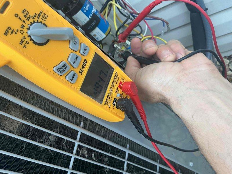Completed comprehensive BFMA tune-up service on Carrier air conditioning system. Performed electrical diagnostics using digital multimeter to verify capacitor functionality and electrical connections, recording measurements within normal operating parameters. Conducted full system inspection of outdoor condenser unit, confirming proper operation of all components and documenting equipment condition through photographic records.