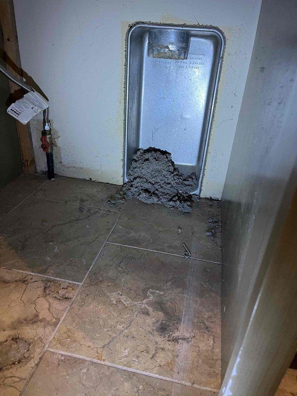 Completed dryer vent cleaning for three-system property with laundry room located on second floor, venting vertically through roof termination. Accessed dryer vent system through interior wall panel and successfully removed significant accumulation of lint, debris, and blockage material that had built up throughout the ductwork run. The substantial amount of extracted material, visible at the access point, indicated a heavily restricted airflow condition that posed both a fire hazard and efficiency concern, which has now been eliminated to restore proper venting function and safety.