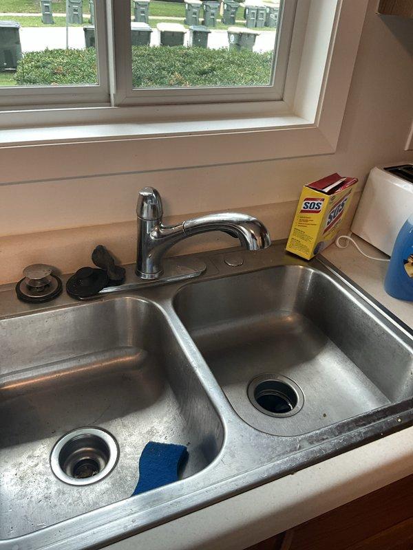 Completed comprehensive plumbing inspection as part of HVAC tune-up service at residential property. Inspected kitchen plumbing fixtures including double-basin stainless steel sink, chrome single-handle faucet, and garbage disposal system, confirming proper operation and drainage. Examined basement utility area plumbing connections, including water heater copper supply lines and associated piping, verifying no visible leaks or corrosion issues requiring immediate attention.