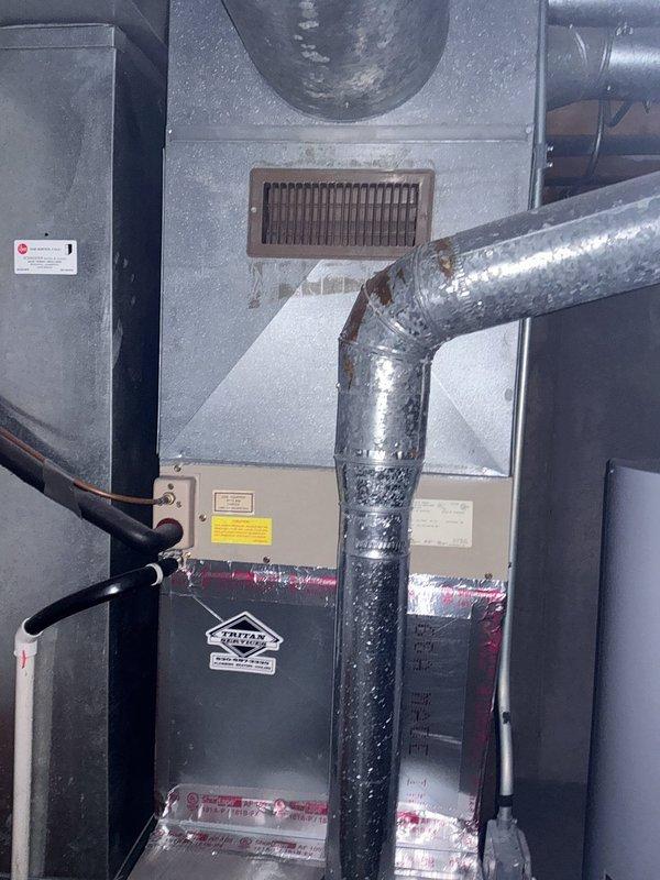 Conducted comprehensive evaluation of existing HVAC system for new homeowner requesting replacement estimate. Inspected indoor furnace unit with attached evaporator coil located in basement mechanical room, noting flexible insulated ductwork connections and electrical components. Assessed outdoor York brand condensing unit positioned on concrete pad against exterior wall, examining condition of unit housing, fan grille, and electrical disconnect. Documented current system configuration including refrigerant line routing and overall installation setup. Provided detailed photographic documentation of both indoor and outdoor equipment for replacement proposal preparation.