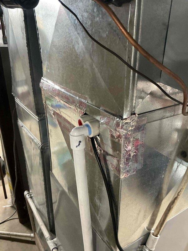 Completed full air conditioning and evaporator coil installation consisting of Lennox ML13KC1-036 outdoor condensing unit and CK40CT-30/36 indoor evaporator coil. Accessed furnace system through rear entrance and integrated new coil with existing ductwork, ensuring proper refrigerant line connections, condensate drainage via PVC piping, and electrical disconnect installation. Unit installed on concrete pad with gravel base, system tested and confirmed operational with proper airflow and cooling performance.