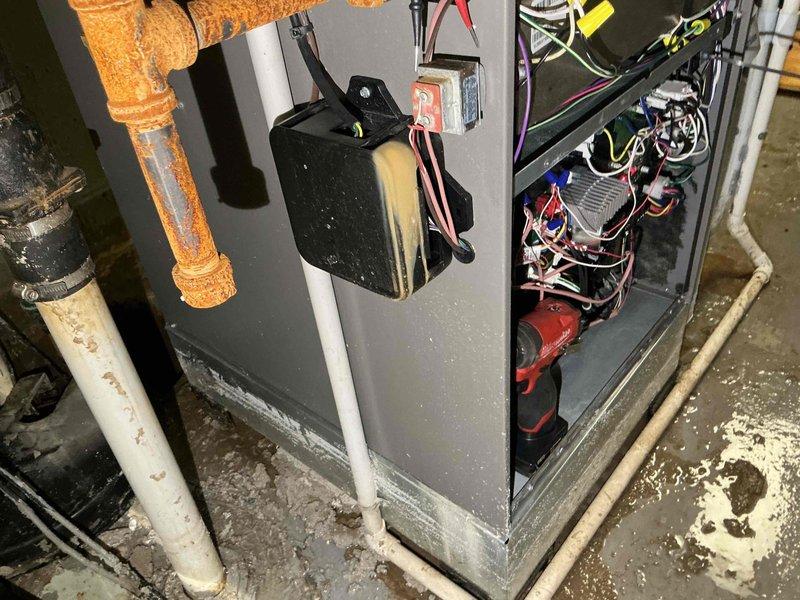 Responded to service call following power outage and flooding event that resulted in approximately 6 inches of water in mechanical room. Performed comprehensive inspection of furnace system to assess potential water damage to electrical components, controls, and mechanical systems. Inspected internal cabinet components, control boards, wiring connections, and condensate pump assembly for signs of water intrusion or moisture damage. Verified all electrical connections were secure and free from corrosion. Checked sump pump and water heater as requested for operational status following flood conditions. Documented visible water staining on concrete floor surrounding equipment and evidence of moisture exposure on copper piping and insulation. All systems inspected and operational status confirmed following power restoration.