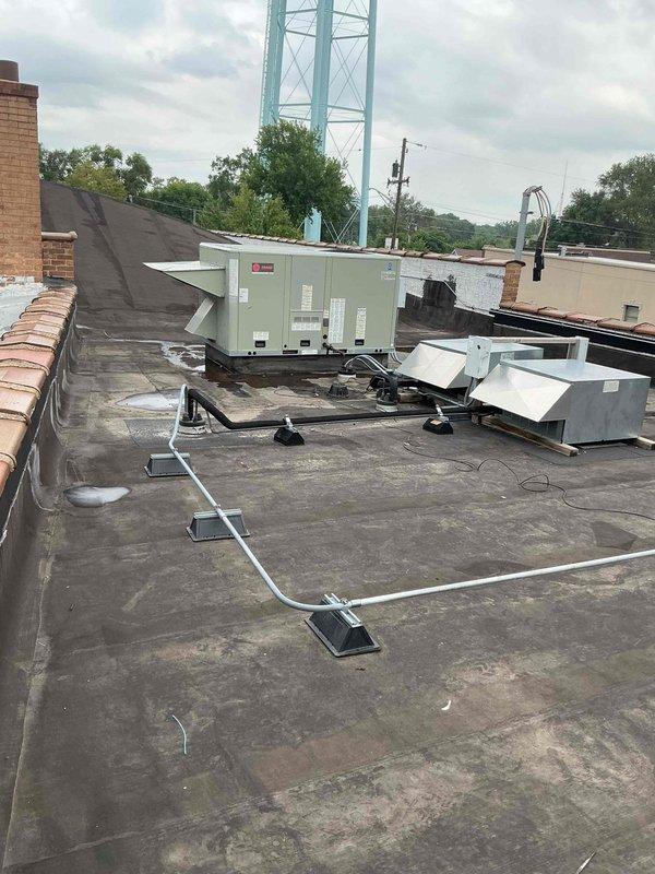 Completed commercial rooftop unit tune-up on 7+ year old HVAC equipment as scheduled first stop of the day. Performed comprehensive preventive maintenance including filter replacement per customer request, system inspection, and operational testing. Both RTU units serviced on flat membrane roof, with all components found operating within normal parameters following tune-up procedures.
