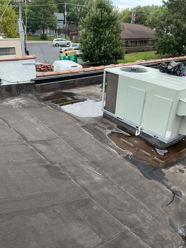 Completed commercial rooftop unit tune-up on 7+ year old HVAC equipment as scheduled first stop of the day. Performed comprehensive preventive maintenance including filter replacement per customer request, system inspection, and operational testing. Both RTU units serviced on flat membrane roof, with all components found operating within normal parameters following tune-up procedures.