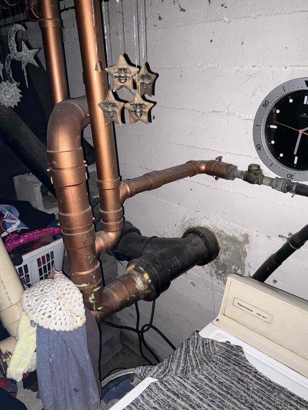 # Sump Pump Inspection

Performed complimentary sump pump inspection at residential property. Examined sump pump discharge piping system, including vertical PVC discharge line with multiple coupling connections secured by metal hose clamps. Verified proper installation of ASTM D2241-rated PVC piping. Inspected associated plumbing infrastructure, including copper supply lines with shut-off valves in basement utility area. Documented current condition of all visible components through photographic records. All systems observed to be in operational condition at time of inspection. No immediate repairs or adjustments required.