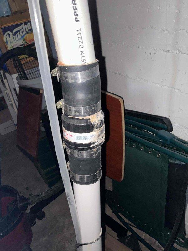 # Sump Pump Inspection

Performed complimentary sump pump inspection at residential property. Examined sump pump discharge piping system, including vertical PVC discharge line with multiple coupling connections secured by metal hose clamps. Verified proper installation of ASTM D2241-rated PVC piping. Inspected associated plumbing infrastructure, including copper supply lines with shut-off valves in basement utility area. Documented current condition of all visible components through photographic records. All systems observed to be in operational condition at time of inspection. No immediate repairs or adjustments required.