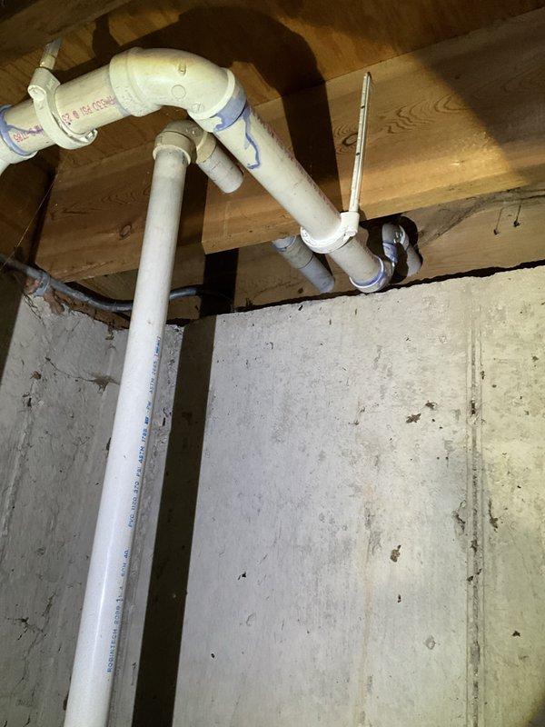 Completed comprehensive inspection of two sump pump systems in accordance with CMC (Comprehensive Maintenance Check) protocol. Both units were evaluated for proper operation, including float switch functionality, discharge piping integrity, and check valve performance. The PVC discharge lines showed appropriate installation with proper venting configuration and secure mounting to floor joists. Electrical connections and conduit installations were inspected and found to be properly secured with appropriate labeling and safety compliance. All components photographed and documented for service records, with both sump pump systems confirmed operational and meeting current plumbing code requirements.