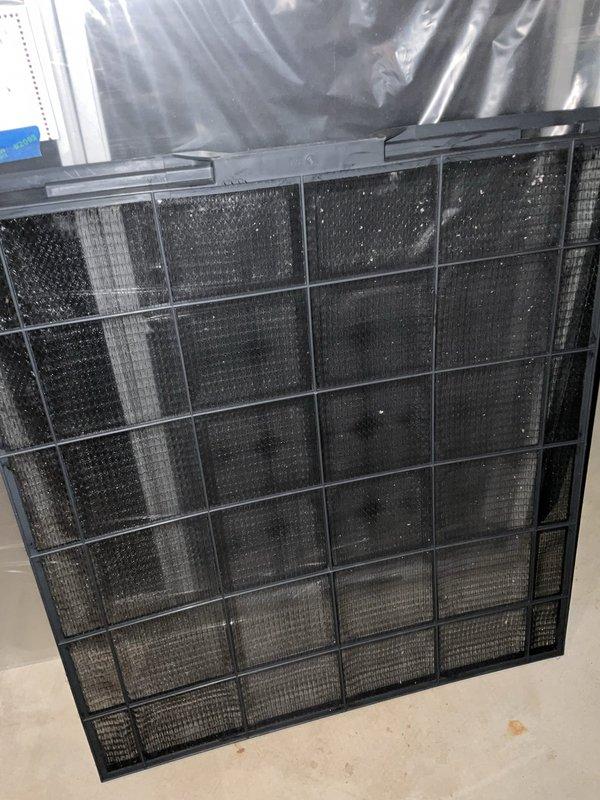 Completed comprehensive BFMA tune-up on 12-year-old residential air conditioning system during scheduled afternoon service window. Performed full system inspection of outdoor condenser unit with cylindrical configuration and horizontal fin design, verified proper operation of all components, and inspected indoor air filtration system. Documented equipment condition through photographic records showing accumulated debris on multi-section air filter requiring attention and well-maintained exterior condenser unit positioned in landscaped area with adequate clearance and drainage.