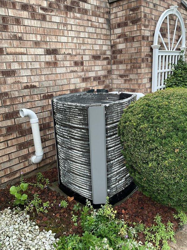 Completed comprehensive BFMA tune-up on 12-year-old residential air conditioning system during scheduled afternoon service window. Performed full system inspection of outdoor condenser unit with cylindrical configuration and horizontal fin design, verified proper operation of all components, and inspected indoor air filtration system. Documented equipment condition through photographic records showing accumulated debris on multi-section air filter requiring attention and well-maintained exterior condenser unit positioned in landscaped area with adequate clearance and drainage.