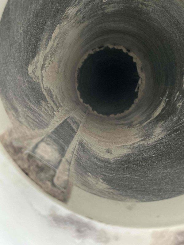 Completed dryer vent cleaning service for residential property. Upon inspection, discovered significant accumulation of lint and debris throughout the ductwork, with heavy buildup coating the interior walls of the exhaust system. Performed thorough cleaning of the dryer vent line, which measured under 15 feet in length. Removed all lint, dust, and fibrous material from the vent passage using professional cleaning equipment. Restored proper airflow and ventilation to prevent potential fire hazards and improve dryer efficiency.