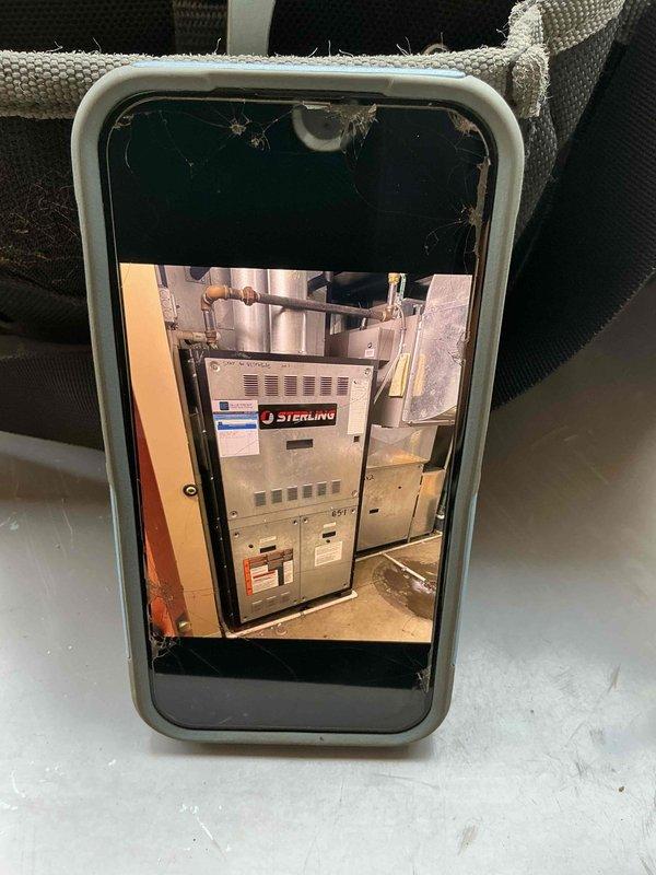 Responded to non-operational air handler complaint at commercial facility. Upon inspection, diagnosed Sterling brand air handler unit in basement utility area and examined associated outdoor condensing unit with refrigerant line connections. Documented equipment conditions including visible corrosion on outdoor unit fittings and assessed system components for proper functionality.