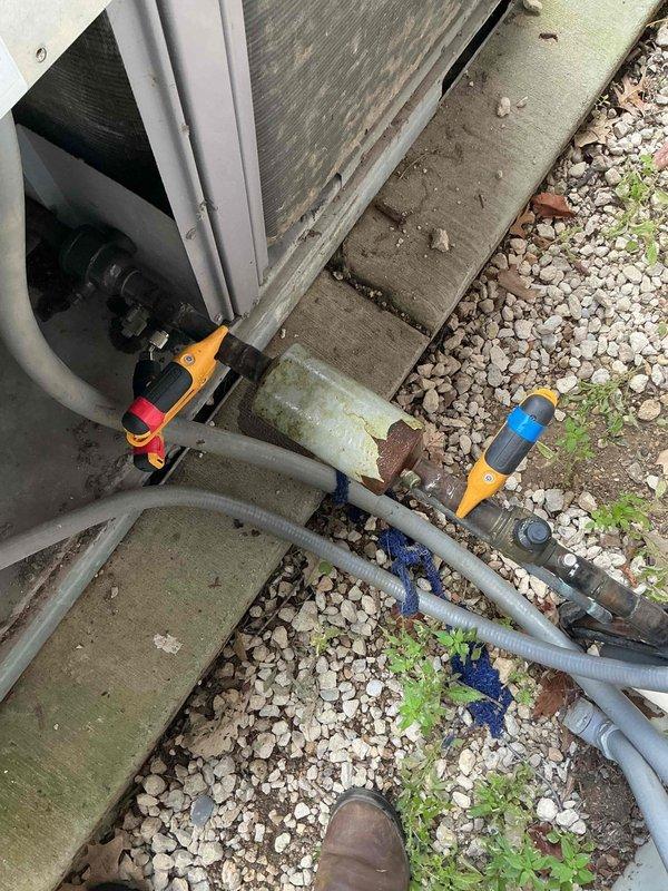 Responded to non-operational air handler complaint at commercial facility. Upon inspection, diagnosed Sterling brand air handler unit in basement utility area and examined associated outdoor condensing unit with refrigerant line connections. Documented equipment conditions including visible corrosion on outdoor unit fittings and assessed system components for proper functionality.