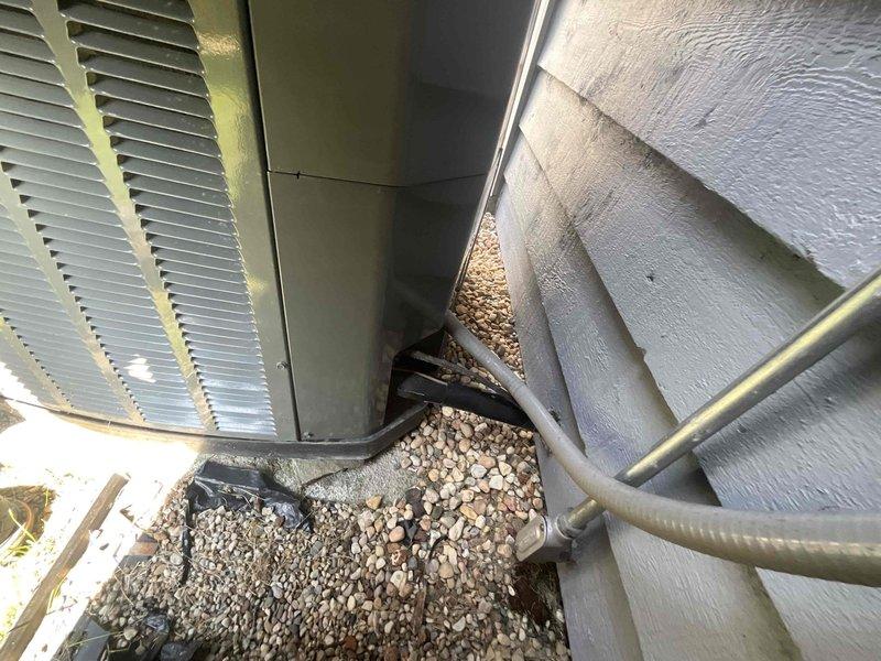 Responded to callback for missing beauty plate on outdoor HVAC installation. Retrieved part from service vehicle and installed beauty plate to cover exposed ductwork connection at exterior wall penetration, restoring proper finished appearance to installation. System components and refrigerant lines verified secure and properly positioned during service visit.
