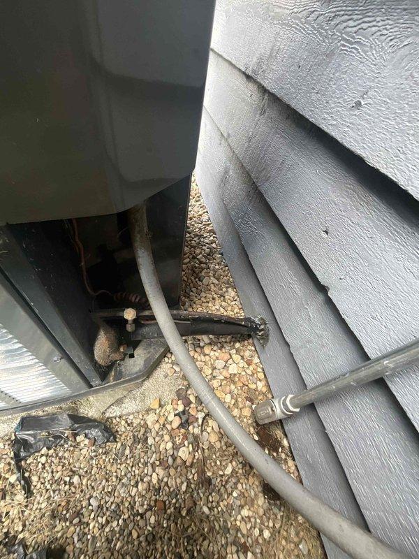 Responded to callback for missing beauty plate on outdoor HVAC installation. Retrieved part from service vehicle and installed beauty plate to cover exposed ductwork connection at exterior wall penetration, restoring proper finished appearance to installation. System components and refrigerant lines verified secure and properly positioned during service visit.
