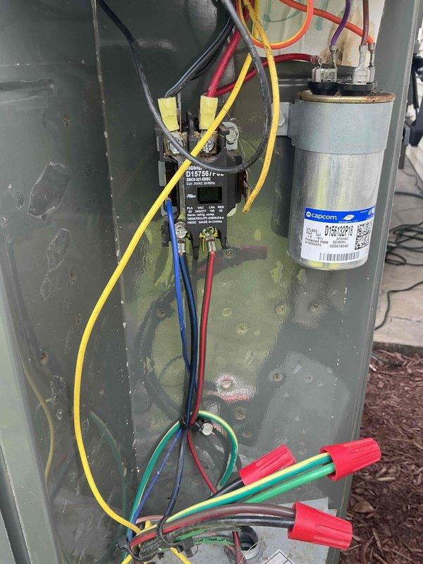 Responded to no-cool call on AC system. Upon arrival, inspected outdoor condenser unit and found contactor and capacitor connections intact with no visible signs of failure. Documented electrical component configuration including contactor relay and cylindrical run capacitor with wiring connections. Advised customer to keep unit off until issue could be properly diagnosed and instructed customer to provide advance notice for return visit to complete troubleshooting and repairs.