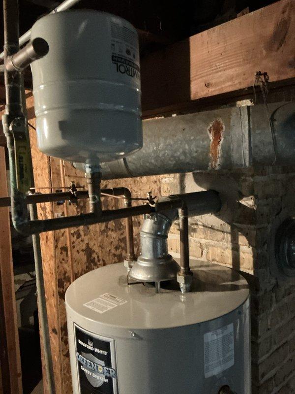 Conducted comprehensive site assessment for new HVAC system installation at residential property with no existing heating and cooling equipment. Evaluated basement mechanical room containing water heater and plumbing infrastructure to determine optimal placement for furnace and air handler components. Assessed existing ductwork conditions, noting aged galvanized metal ducts with surface deterioration requiring replacement or modification. Examined exterior foundation area and identified suitable location for condenser unit placement near existing utility access point. Documented current mechanical room configuration, available clearances, electrical service capacity, and structural considerations for equipment installation. Provided detailed estimate for complete HVAC system including furnace, air conditioning condenser, evaporator coil, ductwork modifications, thermostat installation, and all necessary electrical connections and refrigerant lines.