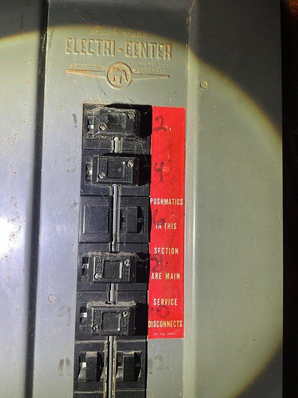 Conducted comprehensive full system HVAC estimate at residential property with cream-colored vinyl siding. Evaluated existing outdoor cylindrical condensing unit positioned on concrete pad with electrical conduit connection to wall-mounted disconnect box. Assessed interior electrical service panel identified as Electri-Center with Pushmatic breakers serving as main service disconnects, noting age-related wear and potential electrical compatibility considerations for new equipment installation. Documented current system configuration and site conditions to develop appropriate equipment replacement recommendations for complete heating and cooling system upgrade.