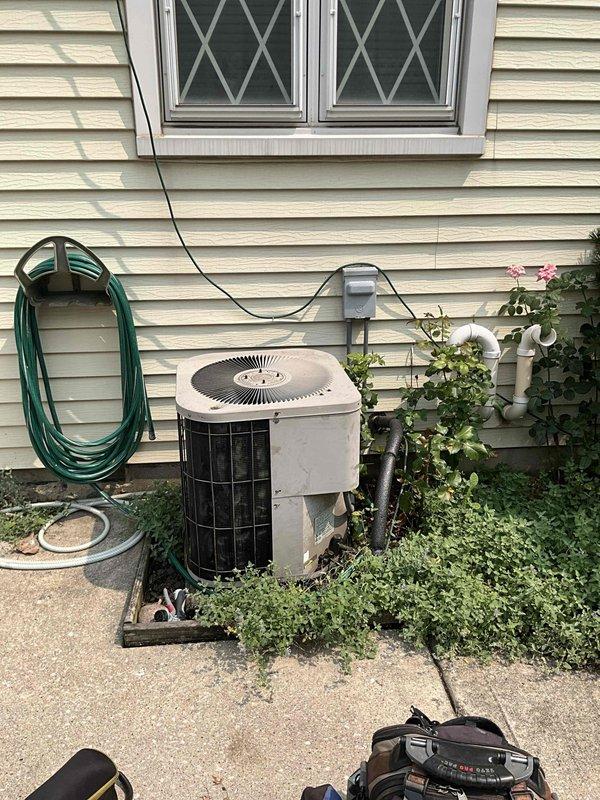 Conducted comprehensive full system HVAC estimate at residential property with cream-colored vinyl siding. Evaluated existing outdoor cylindrical condensing unit positioned on concrete pad with electrical conduit connection to wall-mounted disconnect box. Assessed interior electrical service panel identified as Electri-Center with Pushmatic breakers serving as main service disconnects, noting age-related wear and potential electrical compatibility considerations for new equipment installation. Documented current system configuration and site conditions to develop appropriate equipment replacement recommendations for complete heating and cooling system upgrade.
