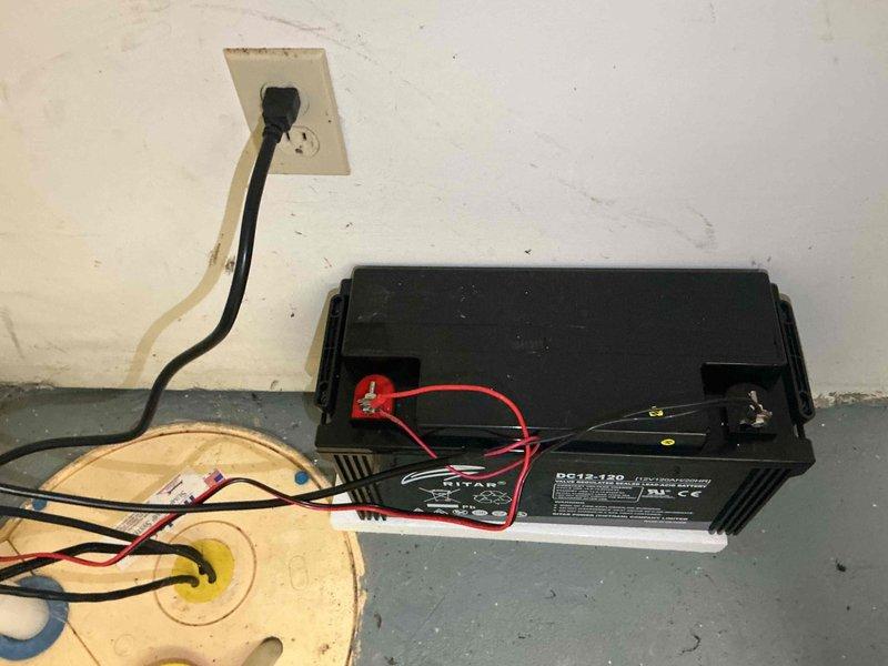 Completed comprehensive sump pump system inspection and maintenance in morning service call. Serviced backup battery system with QS12-120 battery unit, verified electrical connections and power supply functionality, and inspected associated plumbing infrastructure including discharge piping which showed signs of corrosion and age-related deterioration requiring monitoring for future replacement consideration.