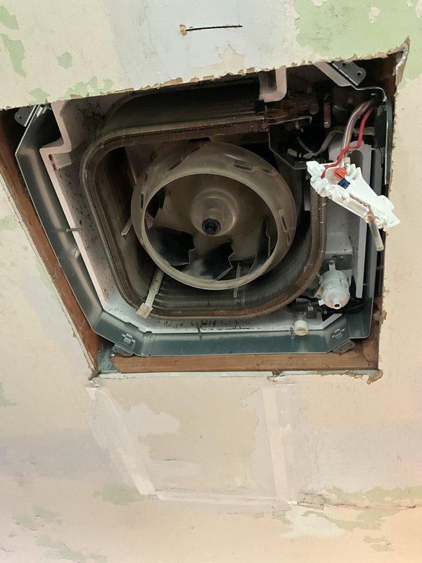 Responded to service call for multiple mini split wall units displaying blinking error codes in utility room and adjacent room following breaker reset. Inspected ceiling-mounted cassette unit to diagnose condensate drainage system issues, specifically examining pump and float switch operation. Due to limited access and tight installation constraints within the cassette housing, was unable to fully remove lower pan assembly to complete pump and float inspection during this visit. Documented installation conditions including flexible ductwork connections, condensate drain line configuration, and blower assembly mounting. Return visit scheduled with additional technician to facilitate complete cassette disassembly and thorough evaluation of drainage components to resolve error codes and restore normal system operation.