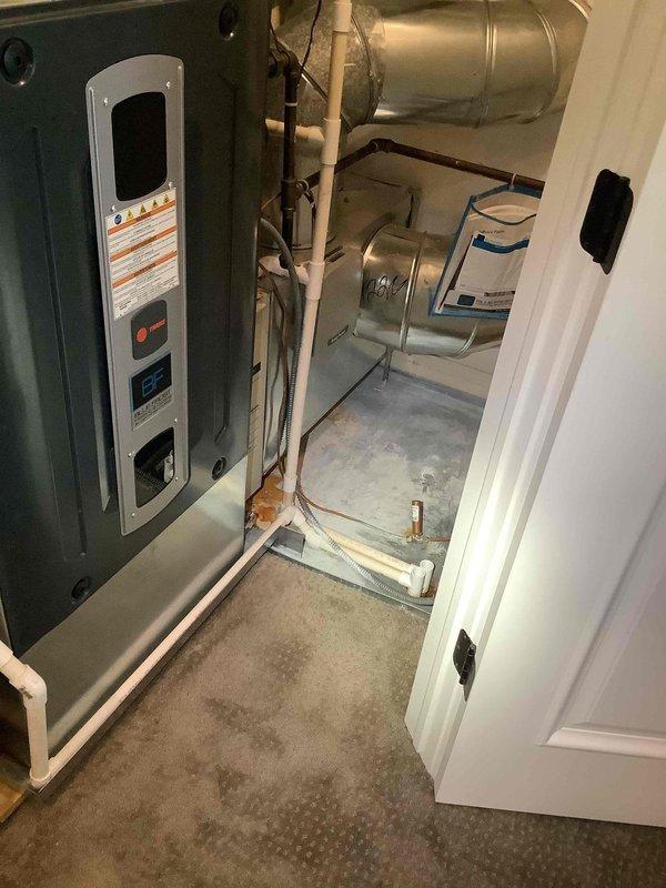 Responded to service call for furnace water leak causing property damage. Upon arrival, found condensate drainage system failure resulting in overflow that filled drain pan and caused wall damage. Inspected HVAC system including furnace unit, condensate pump, and associated drainage lines. Cleared blocked condensate line, verified proper drainage flow, and tested condensate pump operation to ensure system functionality. Repaired copper refrigerant lines and PVC condensate piping connections to prevent future leakage. System restored to normal operation with all drainage components functioning properly.